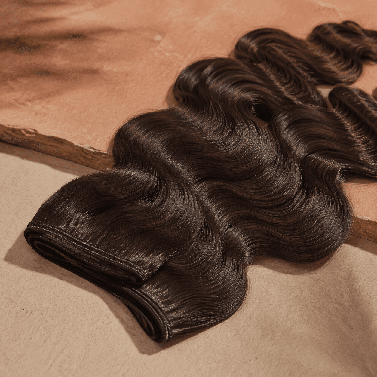 Deep-brown body-wave human hair with reinforced machine-sewn weft tracks