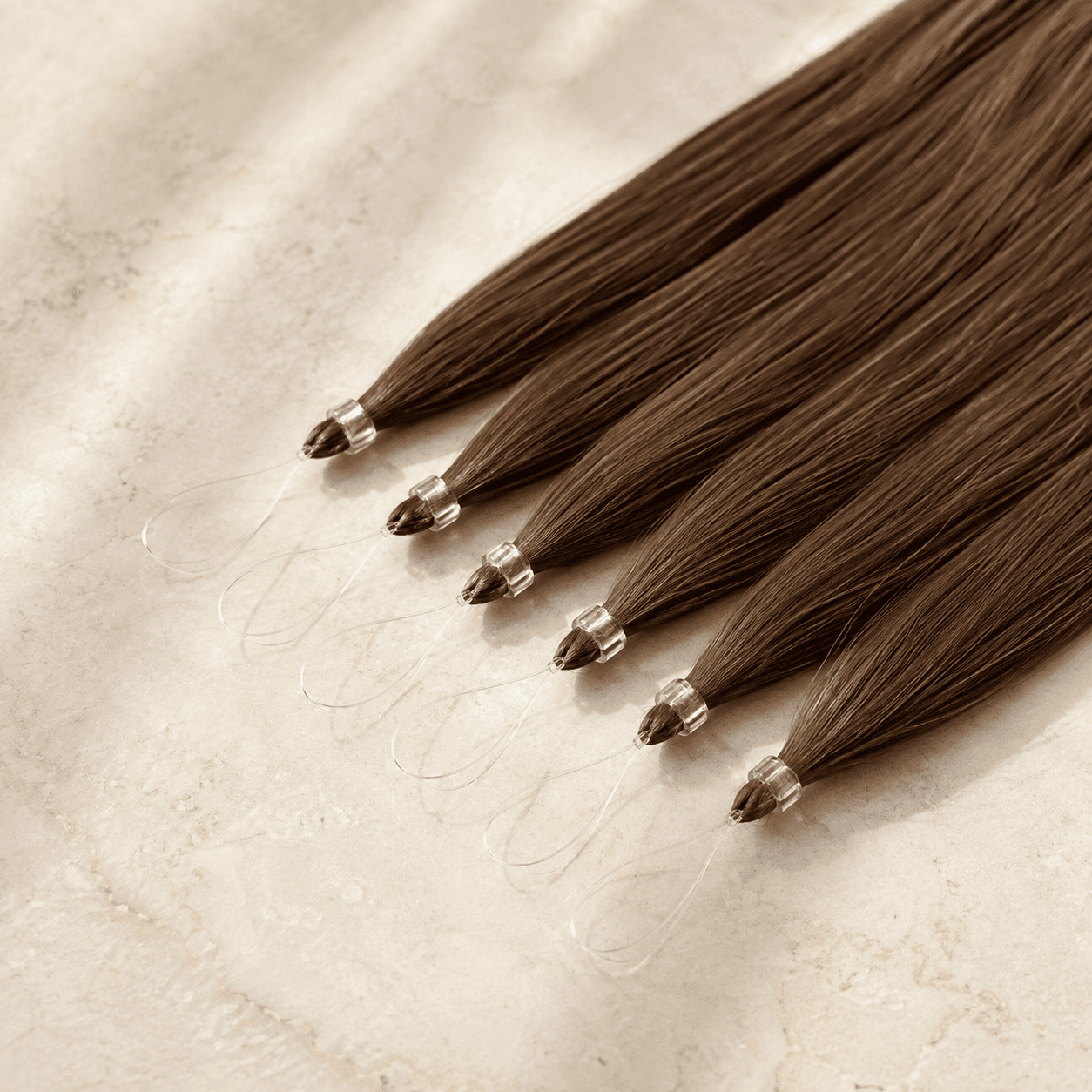 Brown nano ring human hair extension strands with fine loops and small clear beads