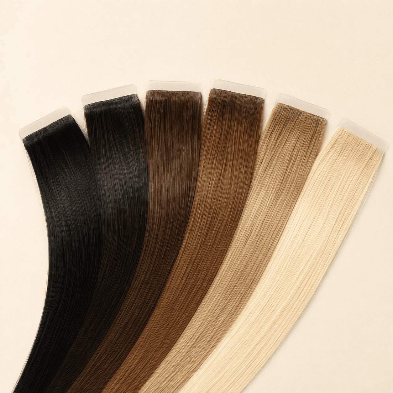 Six invisible tape-in human hair extension shades with translucent tabs
